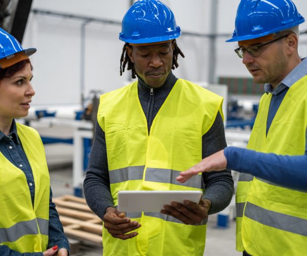Group of engineers consulting results on the tablet